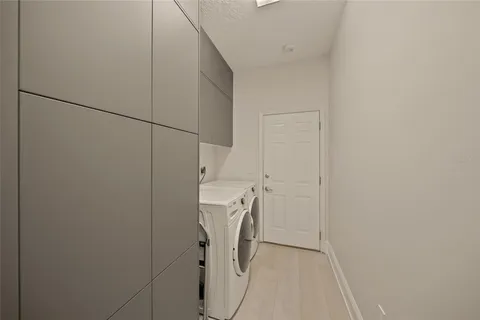 a kitchen with stainless steel appliances kitchen island granite countertop lots of white cabinets