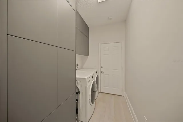 a kitchen with stainless steel appliances kitchen island granite countertop lots of white cabinets