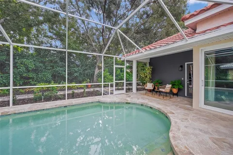 an aerial view of residential houses with outdoor space and trees