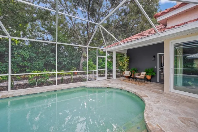 an aerial view of residential houses with outdoor space and trees
