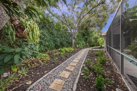 an aerial view of residential houses with outdoor space and trees