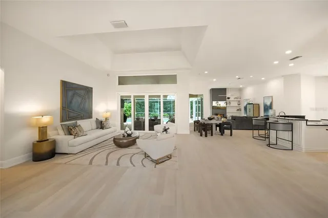 a dining room with furniture and a floor to ceiling window