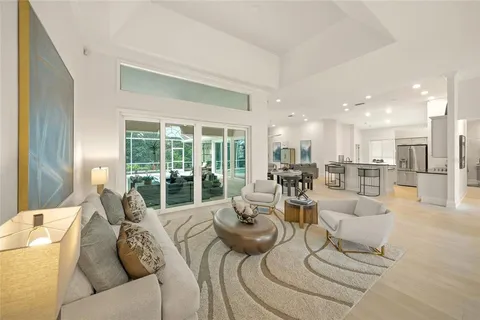 a kitchen with counter space appliances and a view of living room