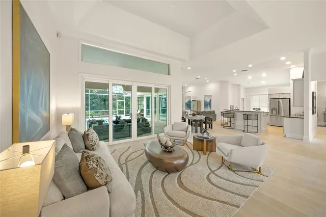 a kitchen with counter space appliances and a view of living room