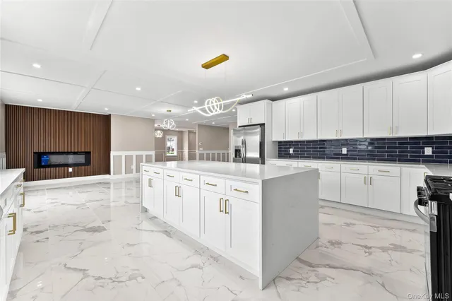 a large kitchen with kitchen island a sink stainless steel appliances and cabinets