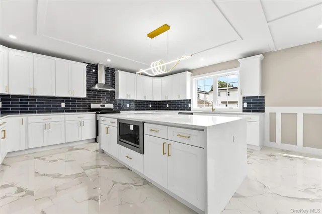 a kitchen with stainless steel appliances granite countertop a stove sink and cabinets