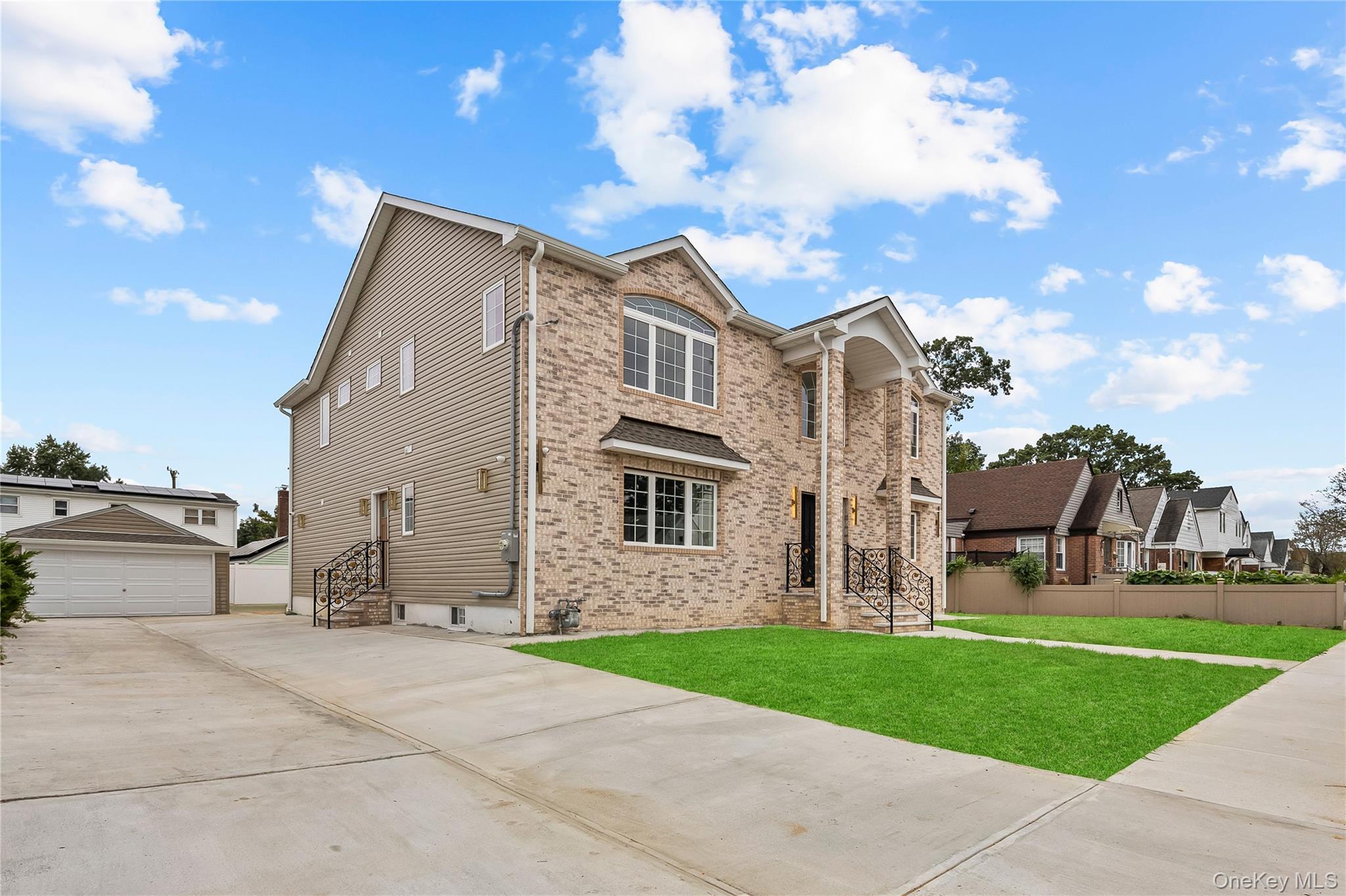 311 Lyon Street Valley Stream, NY 11580 - Photo 2 of 45 a view of a white house next to a yard with big trees
