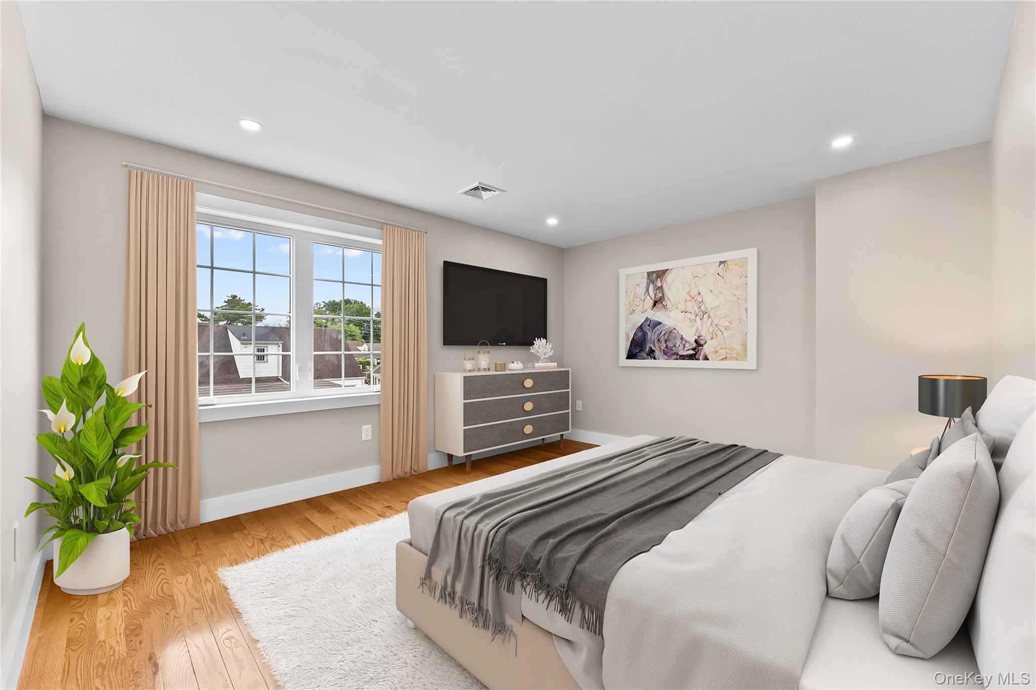 311 Lyon Street Valley Stream, NY 11580 - Photo 29 of 45 a bedroom with a large bed and a flat screen tv