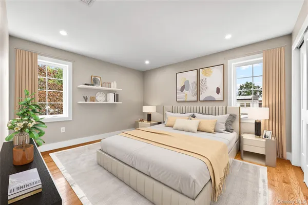 a bedroom with a bed and a flat screen tv in white walls