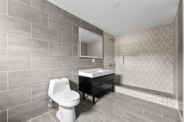 a bedroom with a bed and a night stand