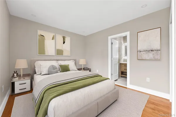 a bedroom with a bed and painting on the wall