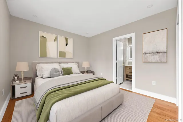 a bedroom with a bed and painting on the wall