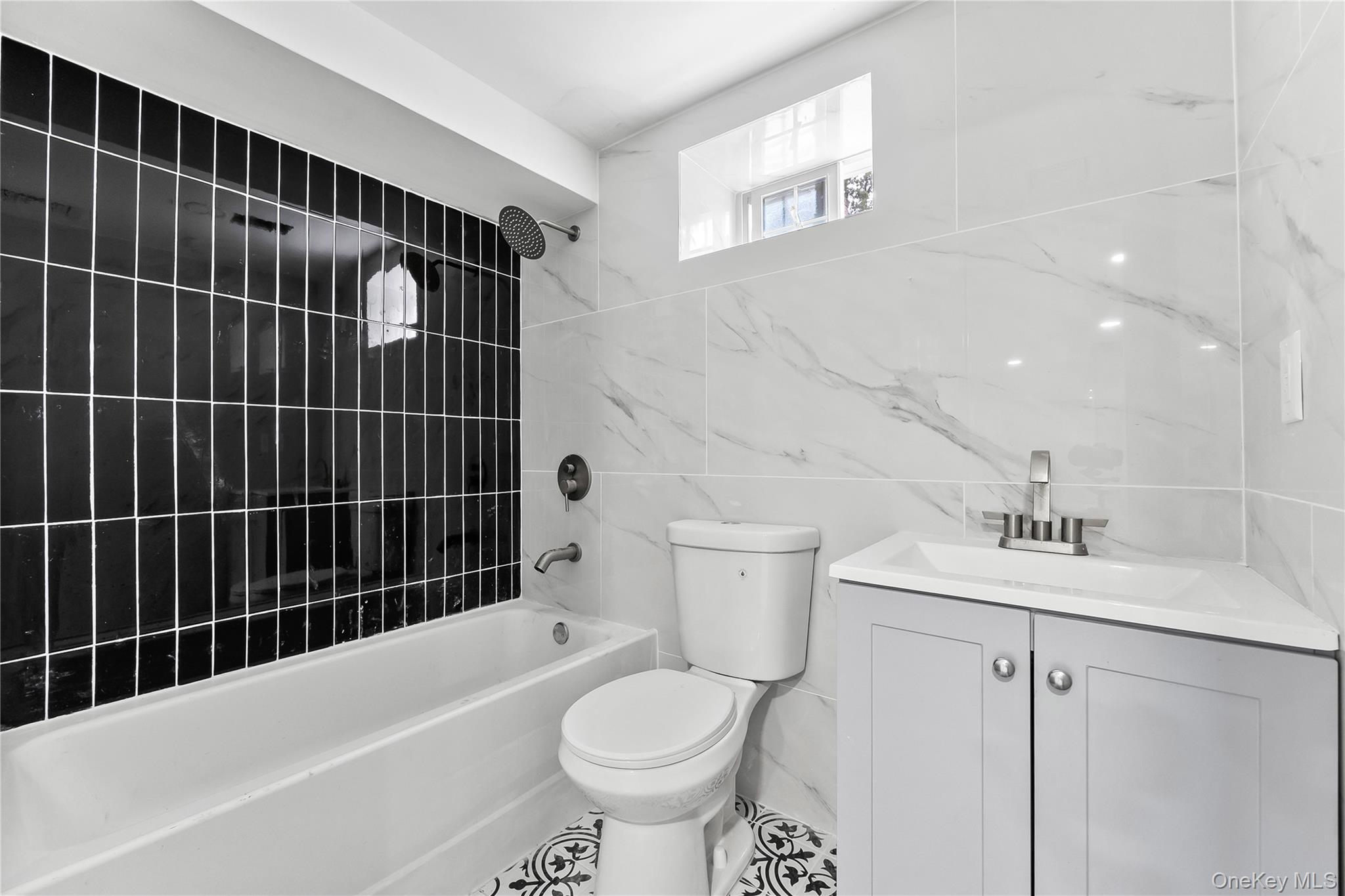 311 Lyon Street Valley Stream, NY 11580 - Photo 43 of 45 a bathroom with a sink toilet vanity and shower