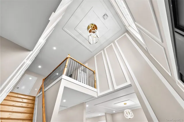 a view of staircase with white walls and a rug