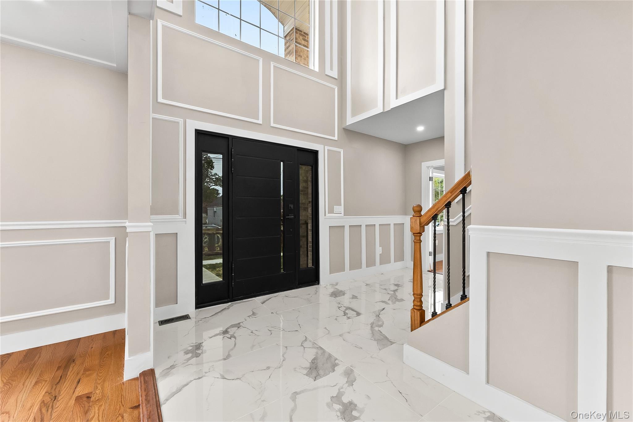 311 Lyon Street Valley Stream, NY 11580 - Photo 7 of 45 a view of a hallway with wooden floor and staircase