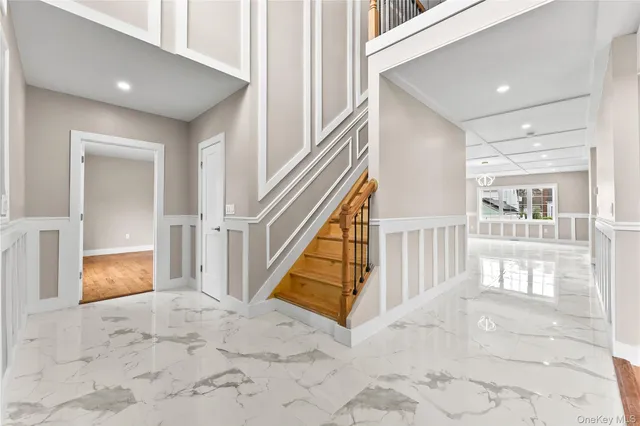 a view of entryway and hall with wooden floor