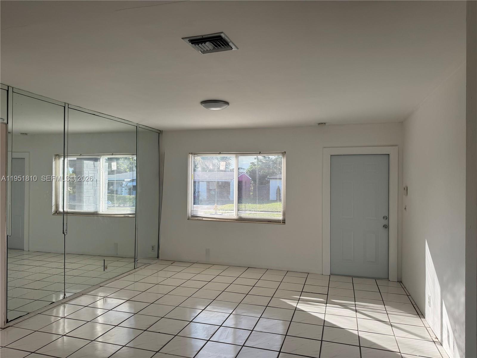 3535 Northwest 82nd Street Miami, FL 33147 - Photo 2 of 14 a view of an empty room with a window