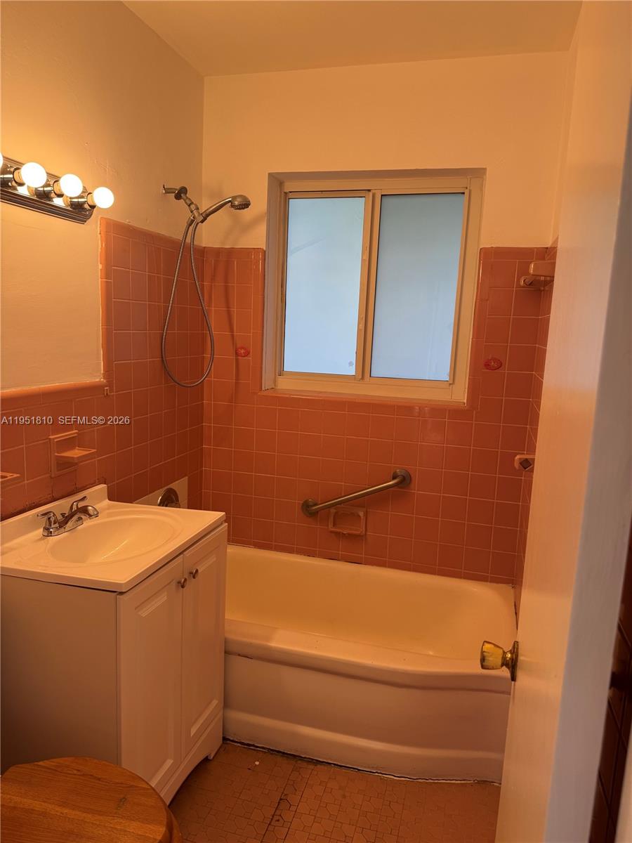 3535 Northwest 82nd Street Miami, FL 33147 - Photo 8 of 14 a bathroom with a sink a toilet and shower