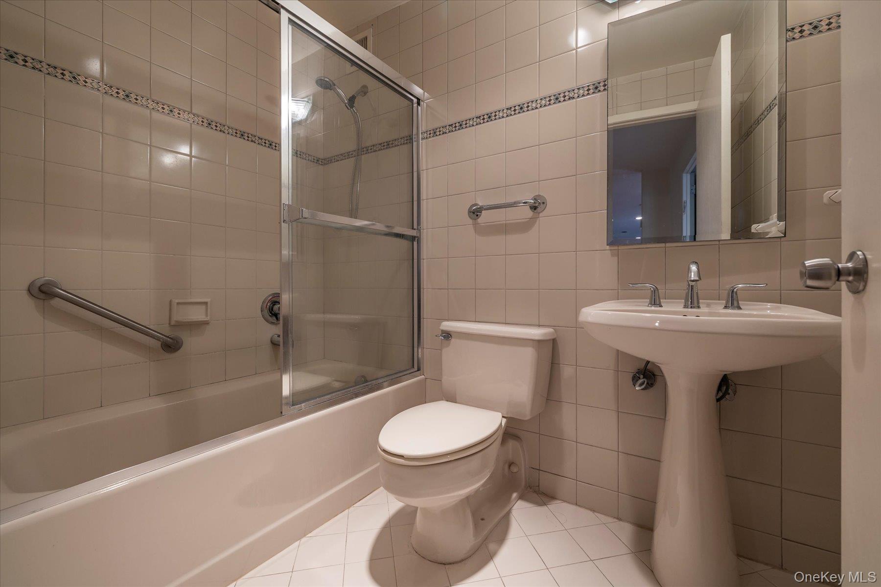 360 Shore Road, Unit 6L & 6M Long Beach, NY 11561 - Photo 17 of 28 a bathroom with a sink toilet and shower