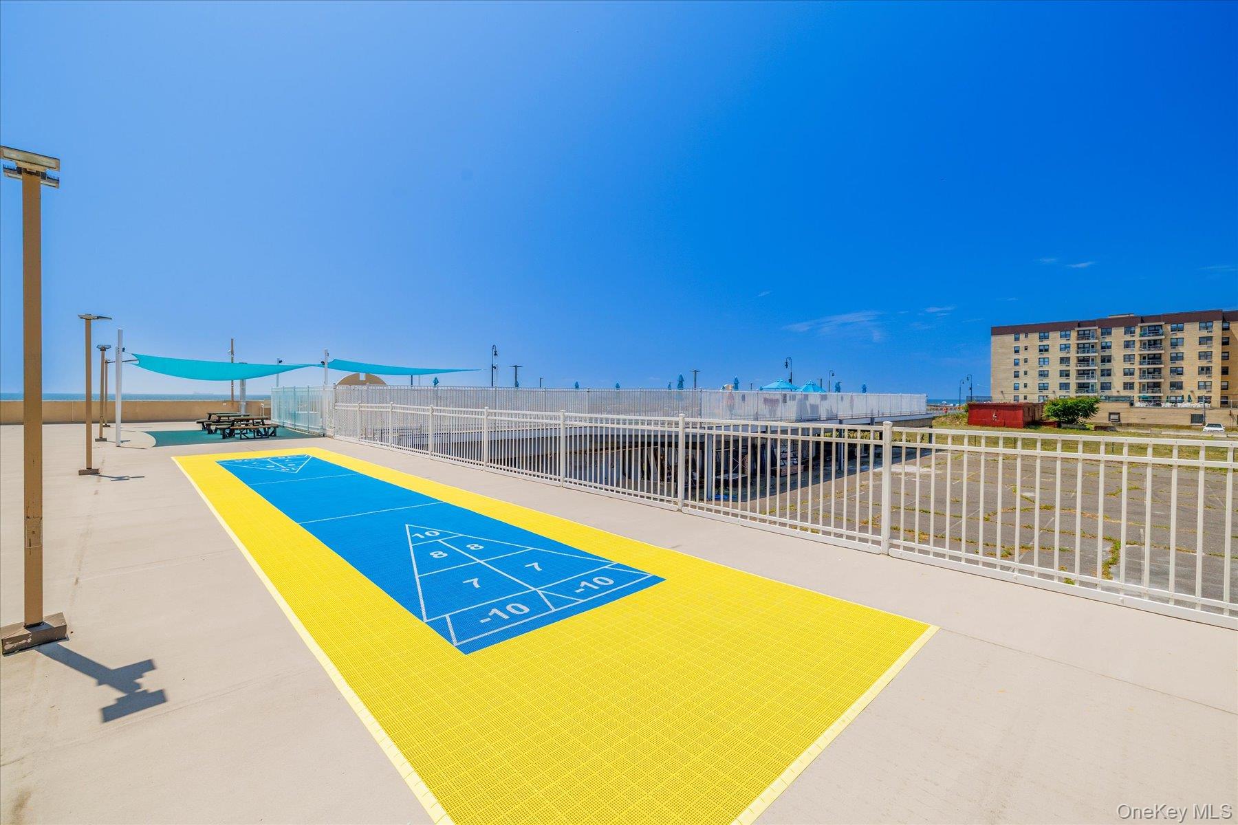 360 Shore Road, Unit 6L & 6M Long Beach, NY 11561 - Photo 27 of 28 a view of a swimming pool with a lounge chairs