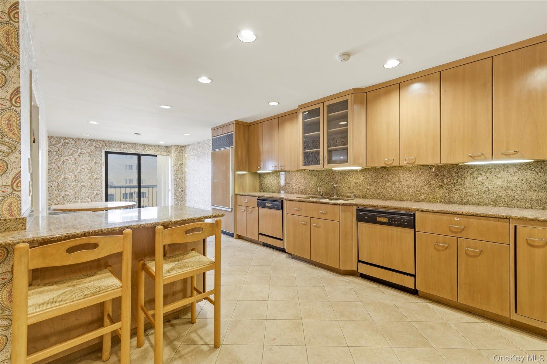 360 Shore Road, Unit 6L & 6M Long Beach, NY 11561 - Photo 3 of 28 a kitchen with granite countertop cabinets and chairs