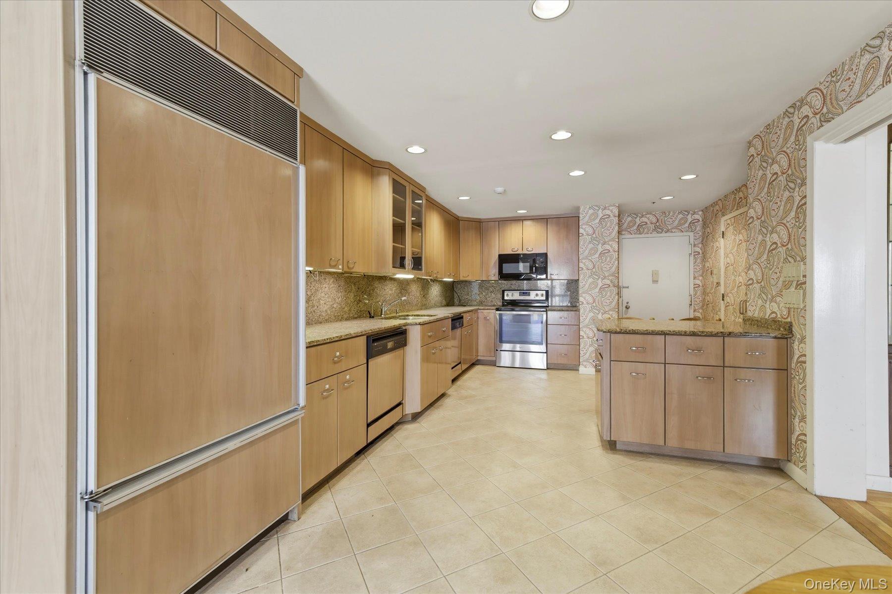 360 Shore Road, Unit 6L & 6M Long Beach, NY 11561 - Photo 4 of 28 a large kitchen with a refrigerator and white cabinets