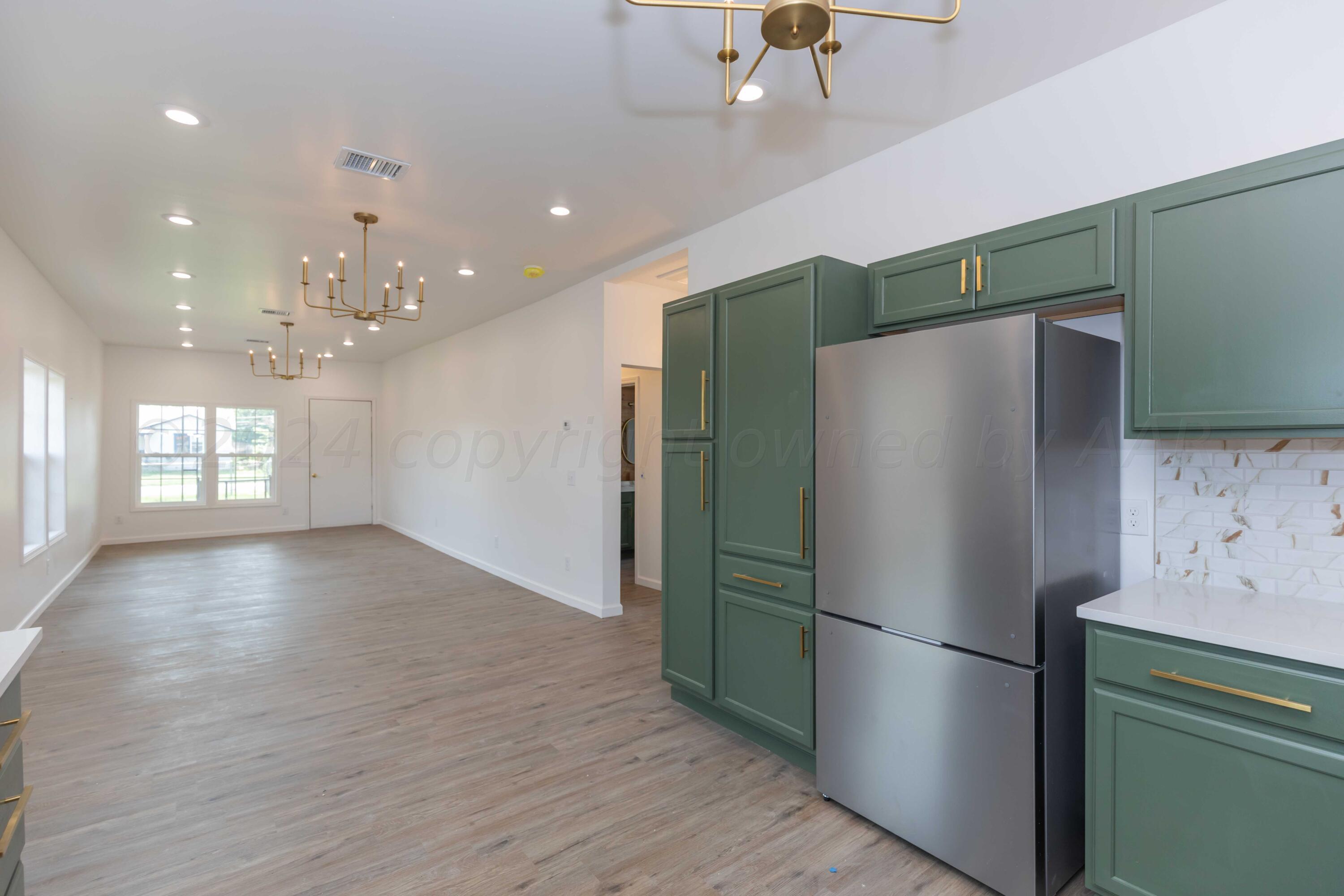 4010 Bowie Street Amarillo, TX 79110 - Photo 8 of 33 a view of a refrigerator in kitchen and wooden floor