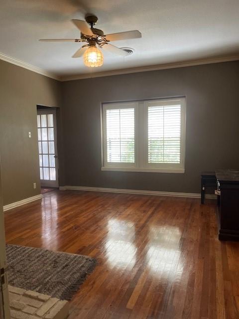 248 South Jacobs Street Albany, TX 76430 - Photo 6 of 17 Den with beautiful hardwood flooring, plantation shutters and crown molding