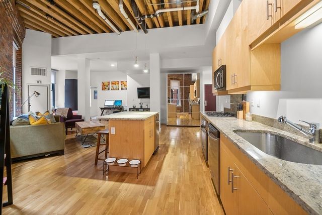 a kitchen with counter top space a sink appliances and cabinets