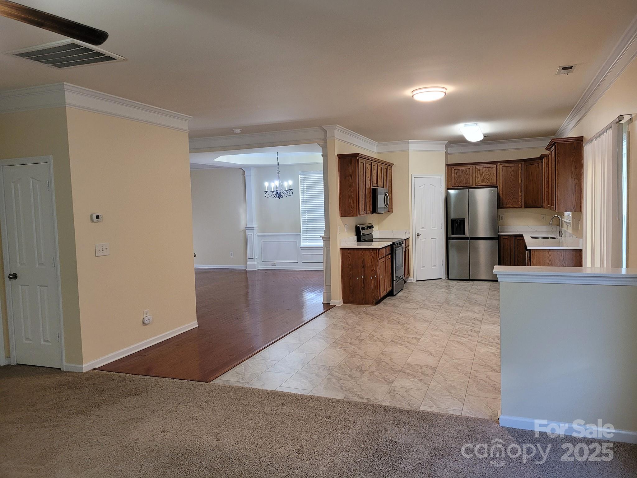 13008 Rothe House Road Charlotte, NC 28273 - Photo 11 of 23 a view of a kitchen with a sink and a refrigerator