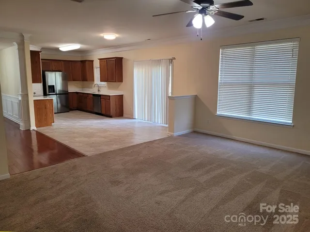 a view of an empty room with window and cabinet