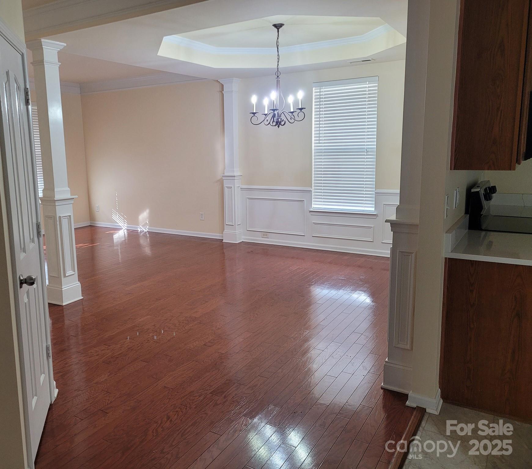 13008 Rothe House Road Charlotte, NC 28273 - Photo 17 of 23 a view of an empty room with window and wooden floor