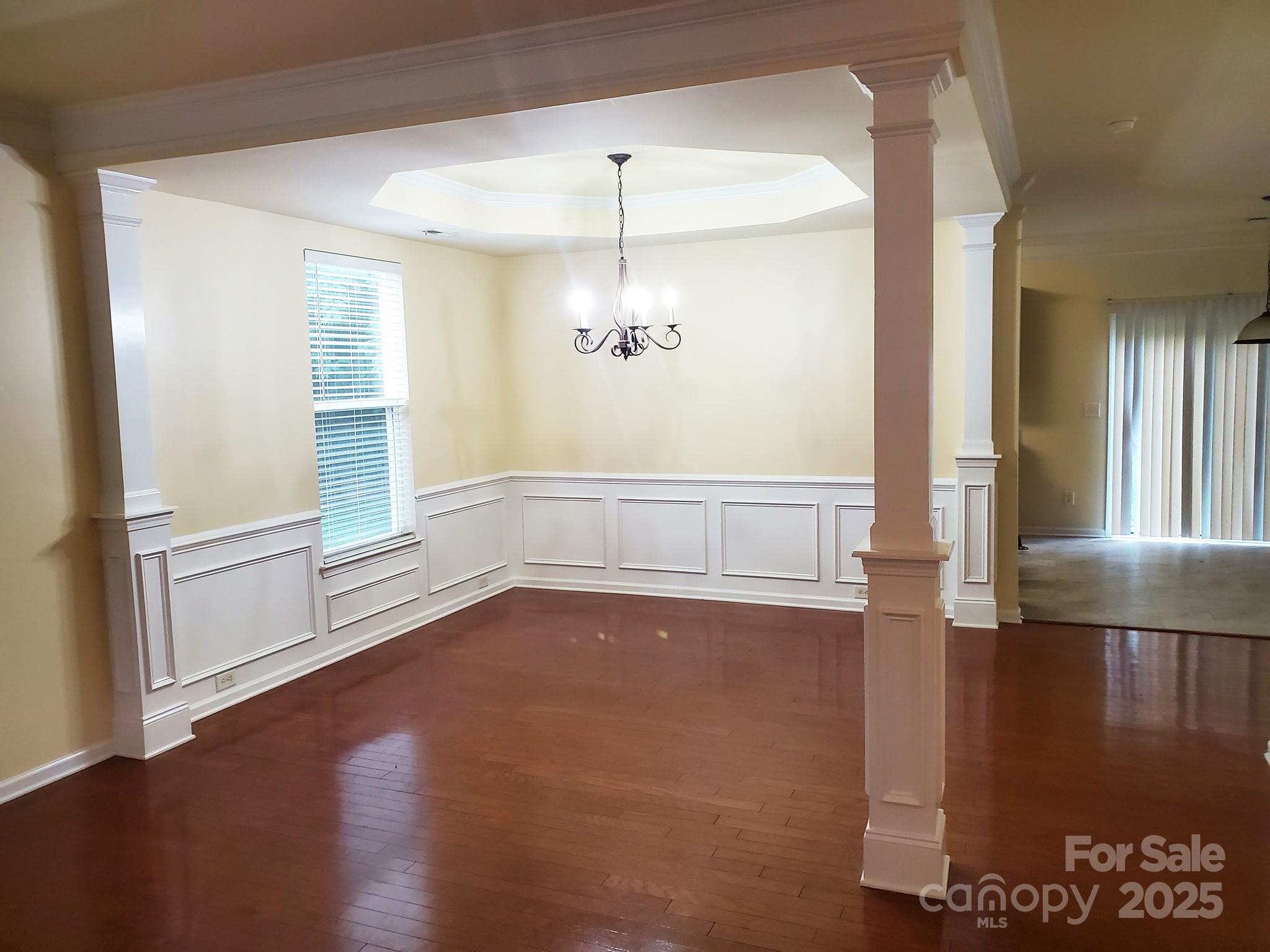 13008 Rothe House Road Charlotte, NC 28273 - Photo 3 of 23 wooden floor in an empty room with a window