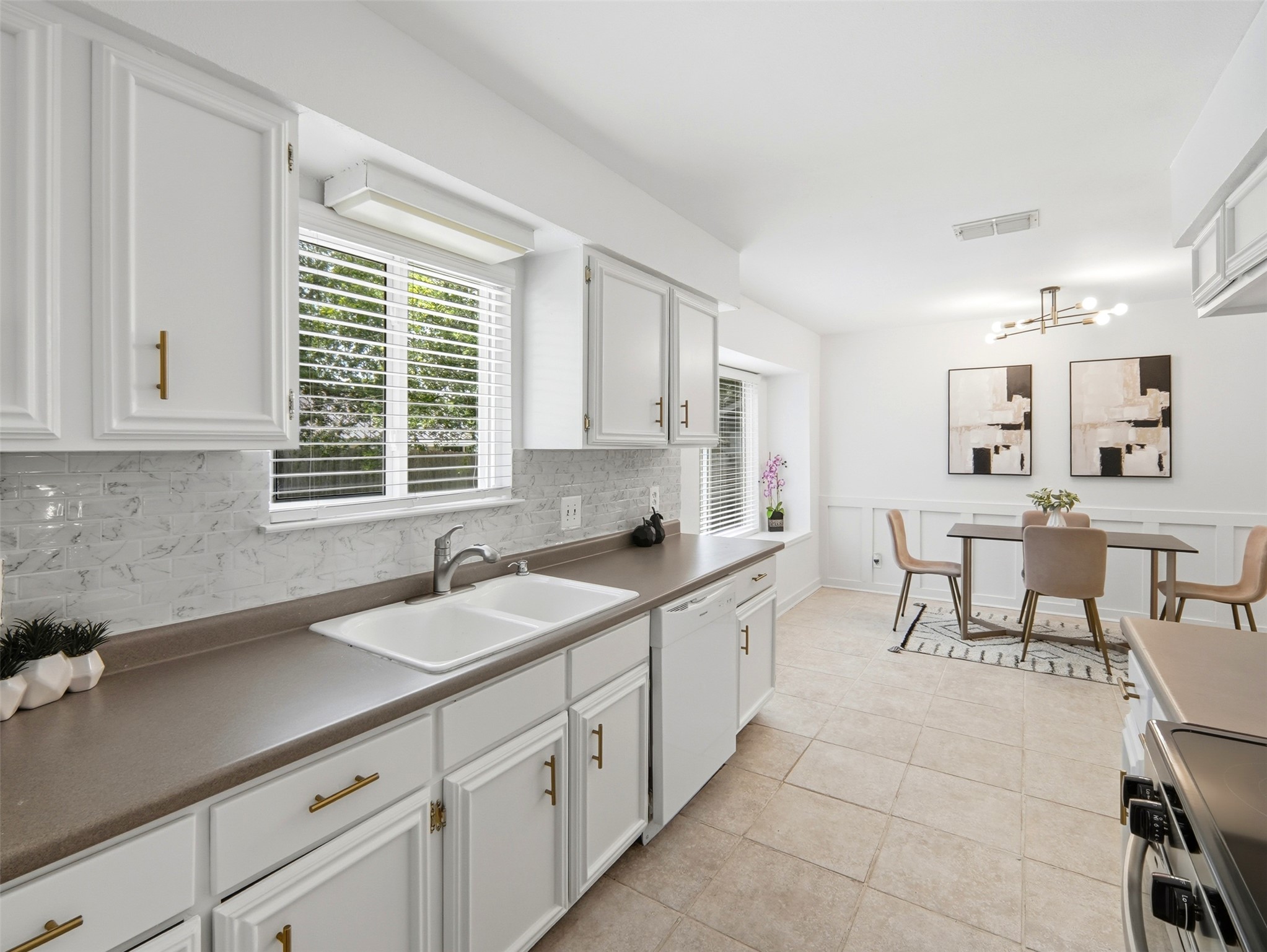 7001 Windrift Way Austin, TX 78745 - Photo 5 of 17 A well-lit kitchen with ample counter space connects seamlessly to a cheerful dining area.