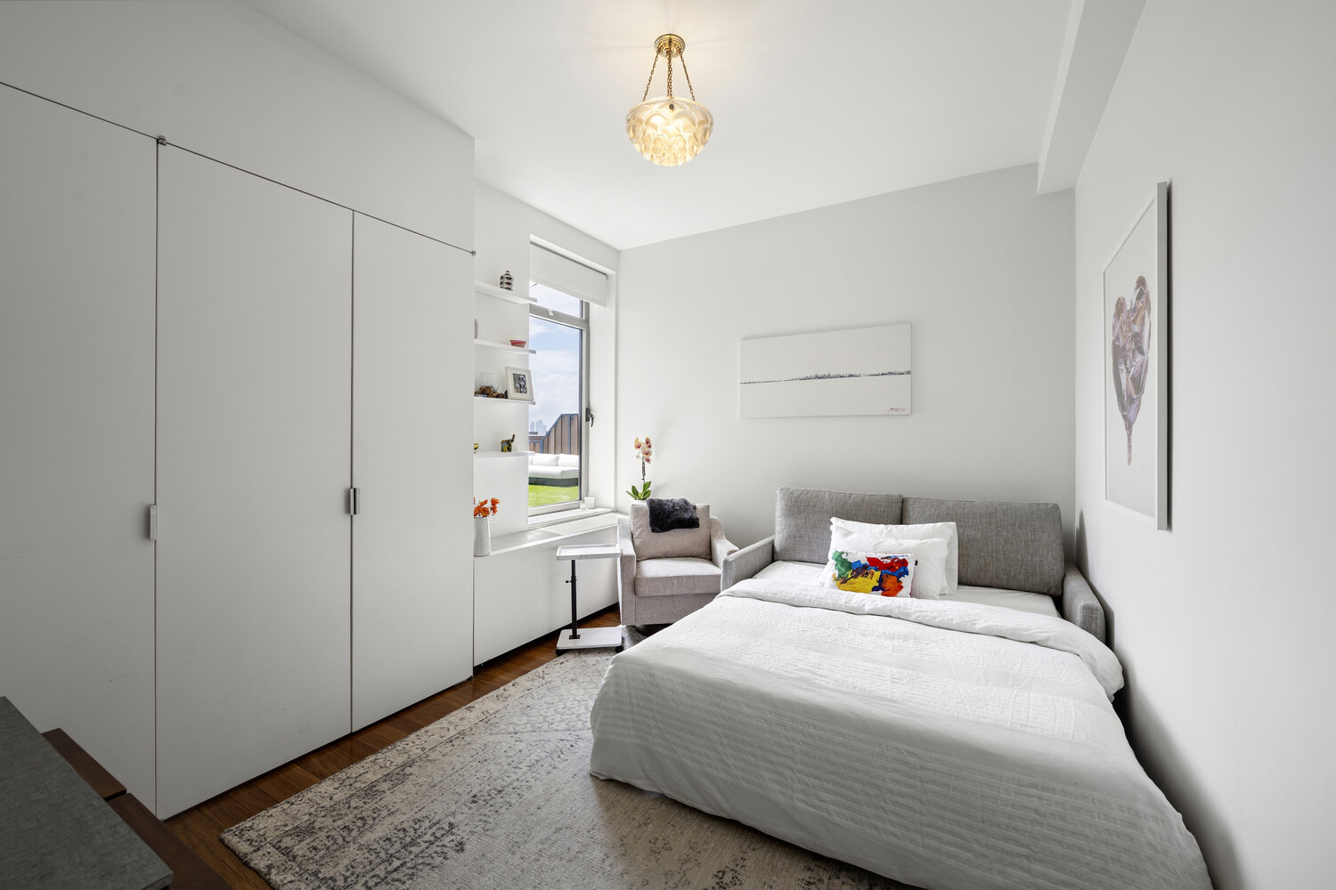 252 7th Avenue, Unit 15N Manhattan, NY 10001 - Photo 10 of 15 a bedroom with a bed and a window