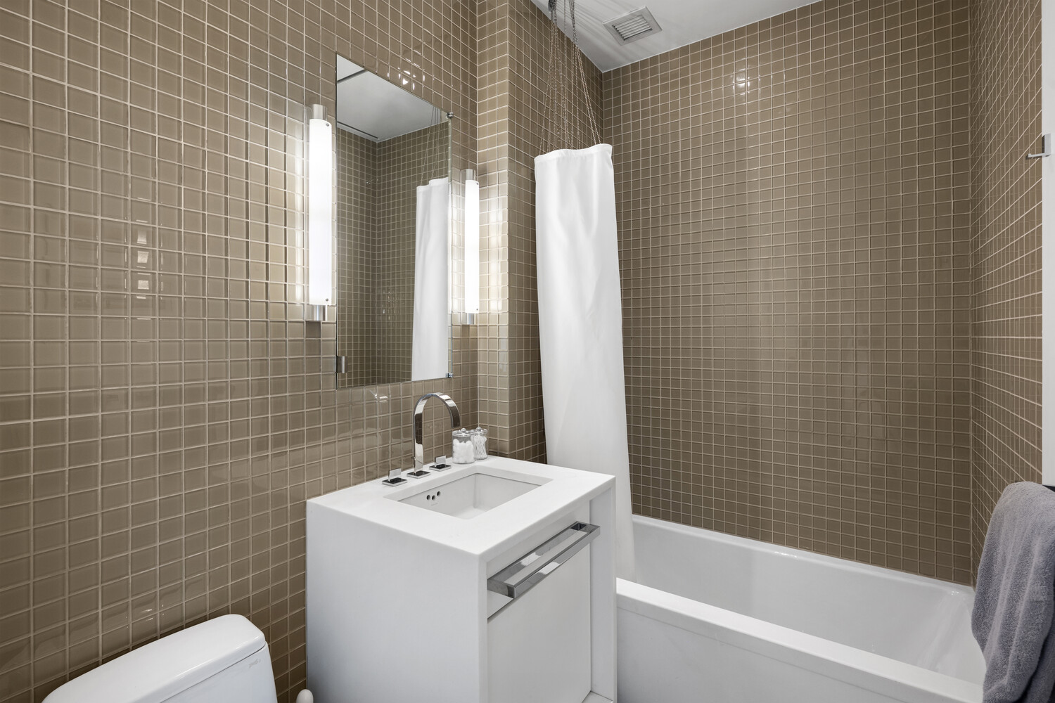 252 7th Avenue, Unit 15N Manhattan, NY 10001 - Photo 11 of 15 a bathroom with a sink toilet and shower