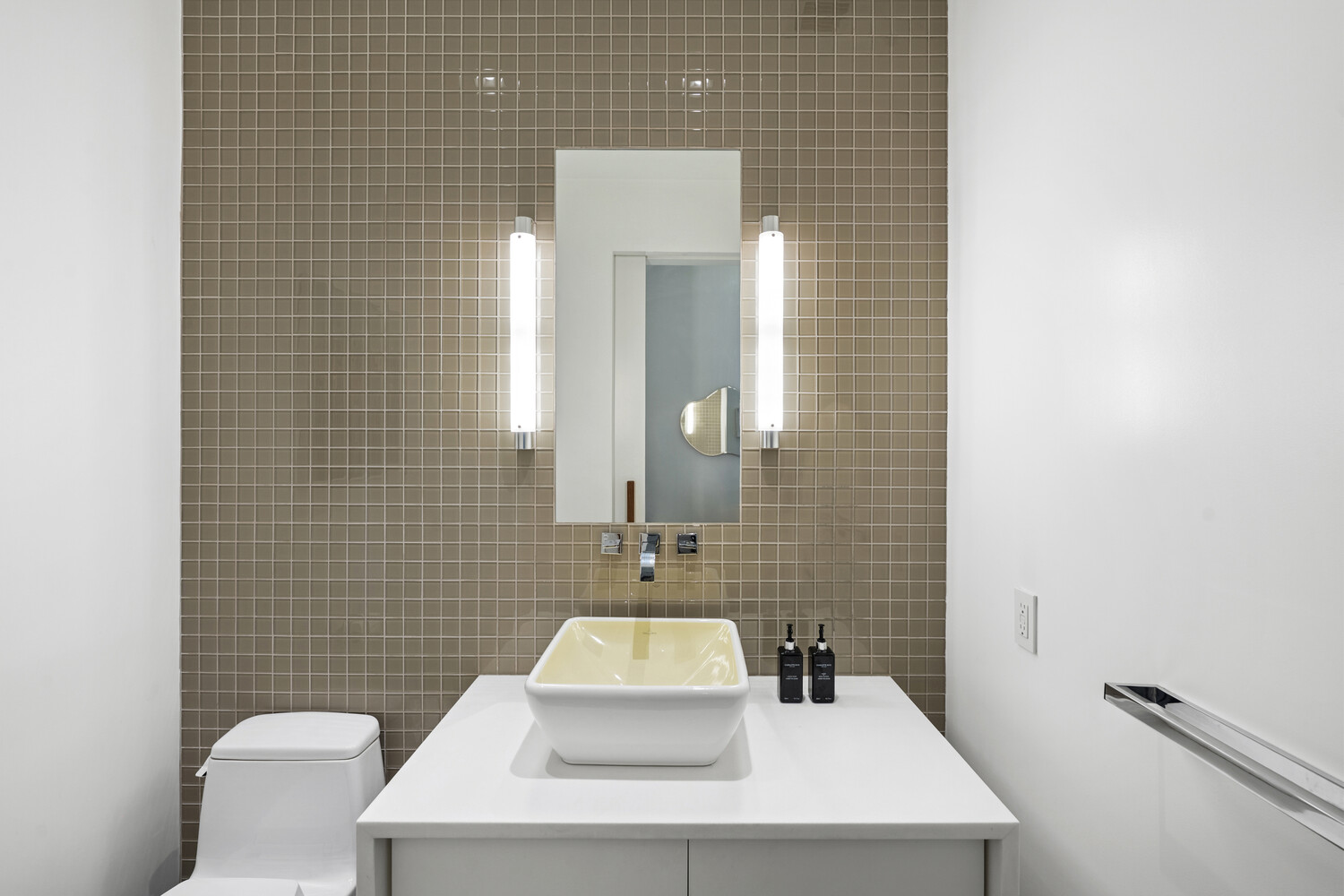 252 7th Avenue, Unit 15N Manhattan, NY 10001 - Photo 13 of 15 a bathroom with a sink a toilet and mirror