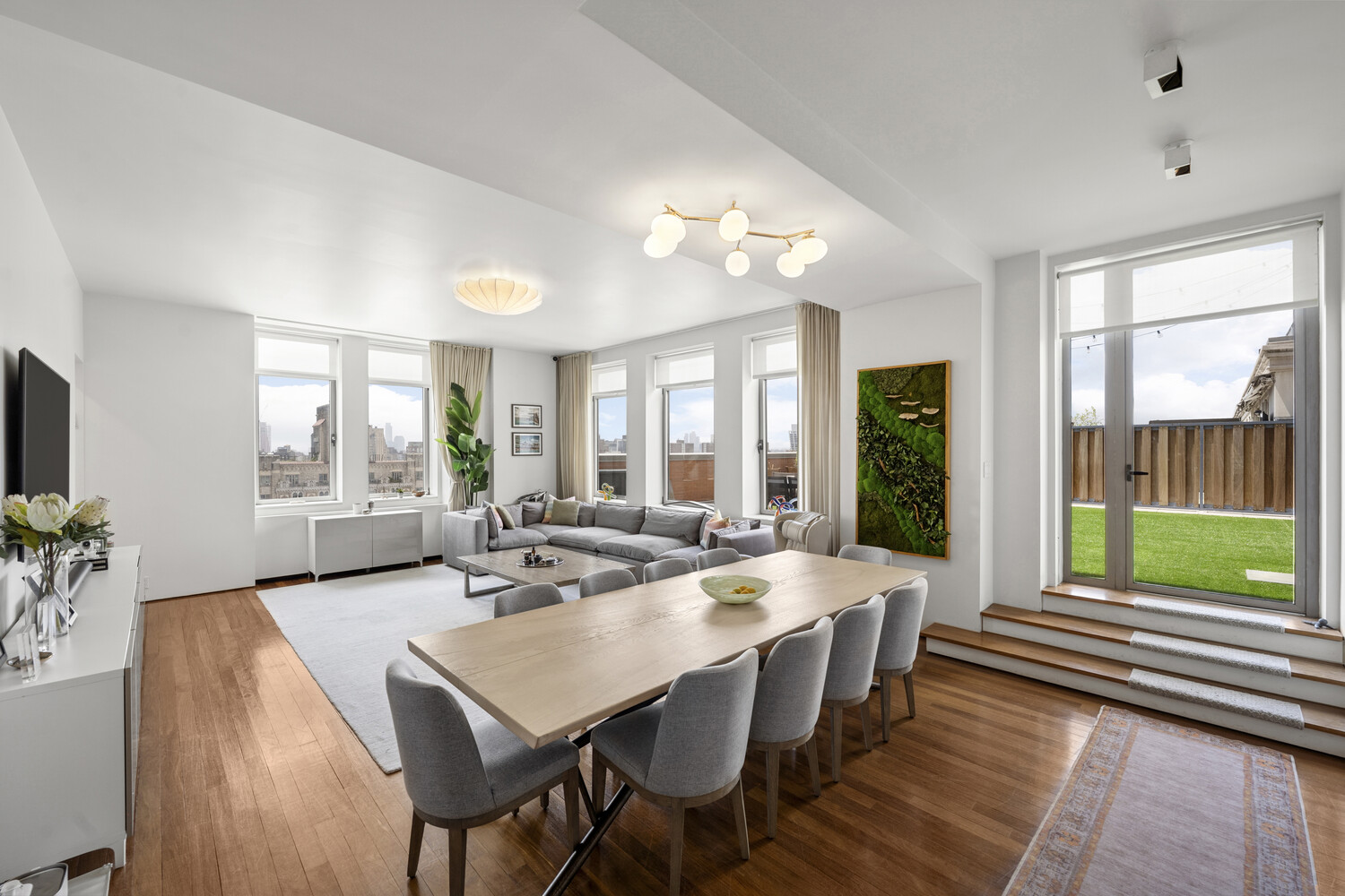 252 7th Avenue, Unit 15N Manhattan, NY 10001 - Photo 2 of 15 a view of a dining room with furniture large windows and wooden floor