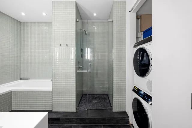 a bathroom with a double vanity sink a toilet and a mirror