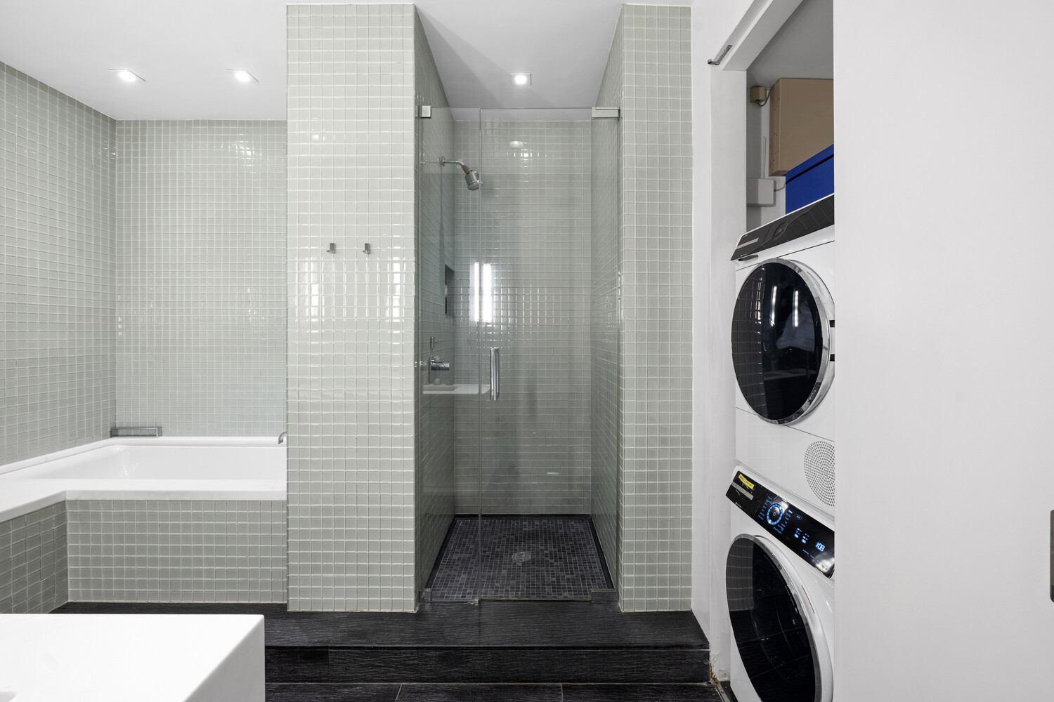 252 7th Avenue, Unit 15N Manhattan, NY 10001 - Photo 9 of 15 a bathroom with a sink a shower and a mirror