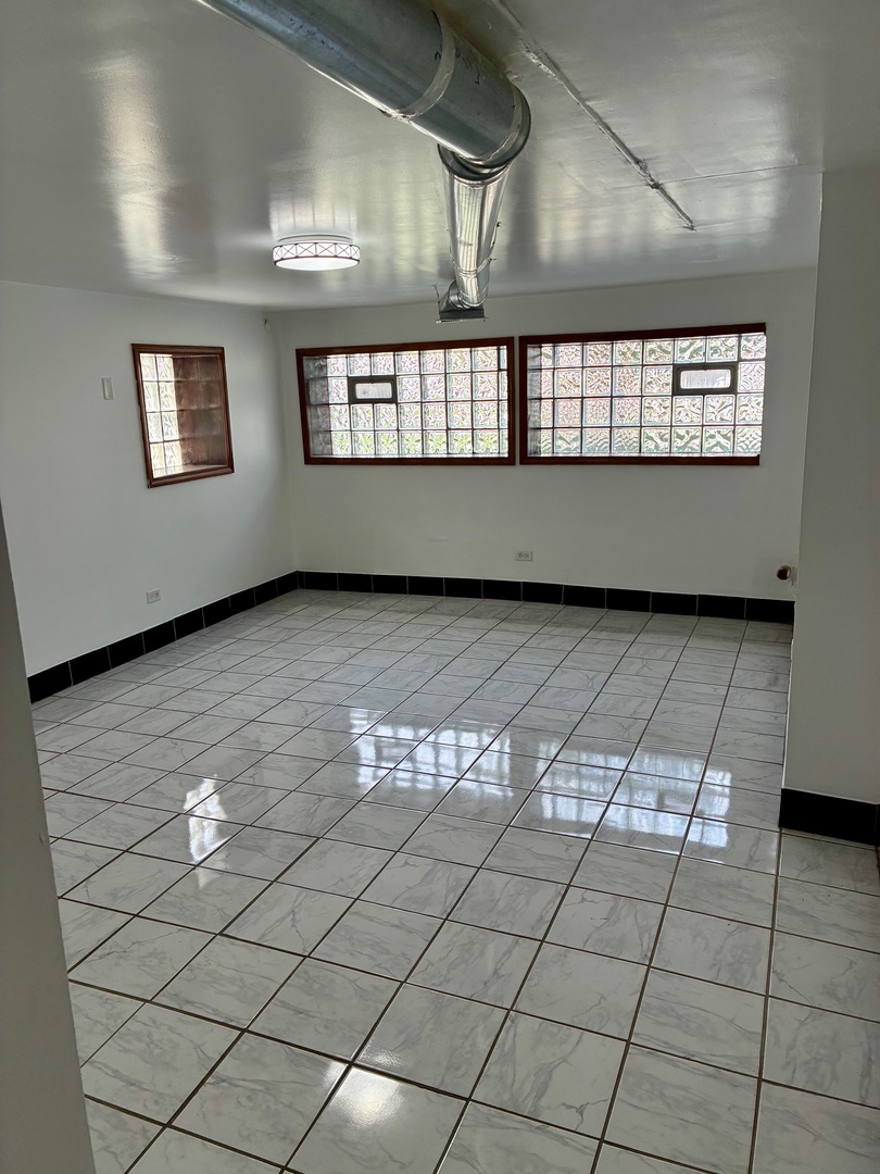 1111 North Leclaire Avenue, Unit B Chicago, IL 60651 - Photo 2 of 11 a view of an empty room and window
