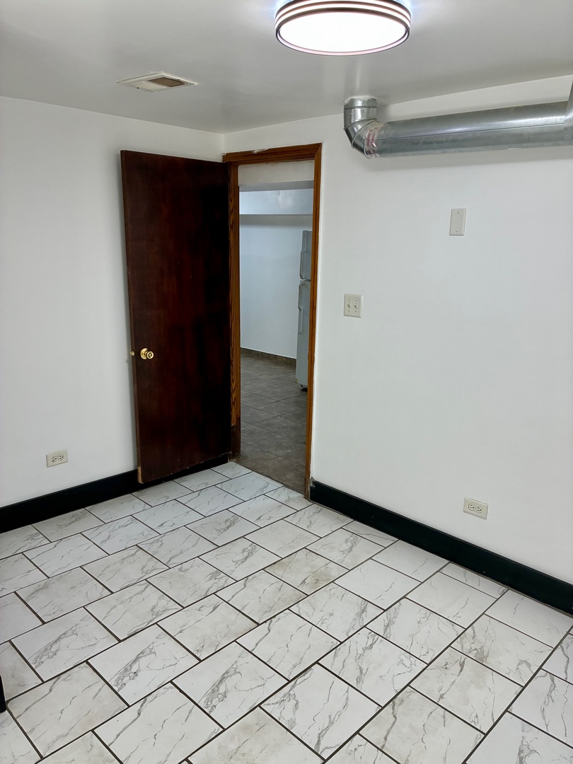 1111 North Leclaire Avenue, Unit B Chicago, IL 60651 - Photo 8 of 11 a view of a livingroom with wooden floor
