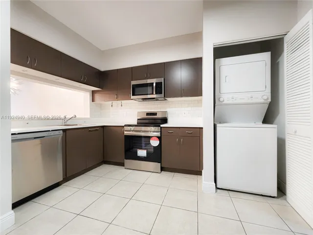 a kitchen with a refrigerator and a counter top space