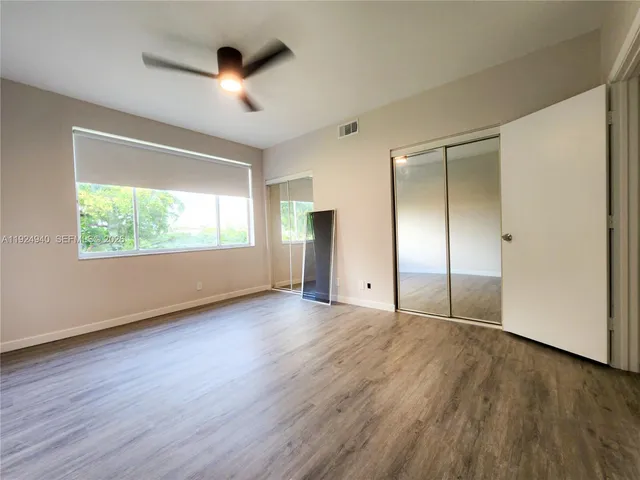 a bathroom with a toilet a sink a vanity and mirror