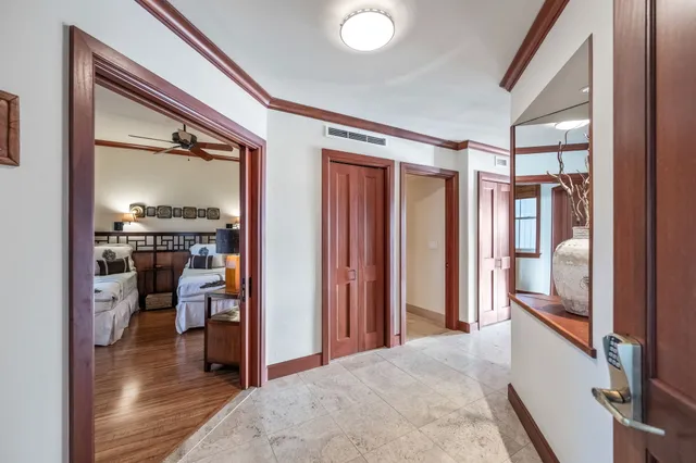 a view of a hallway and a livingroom with furniture