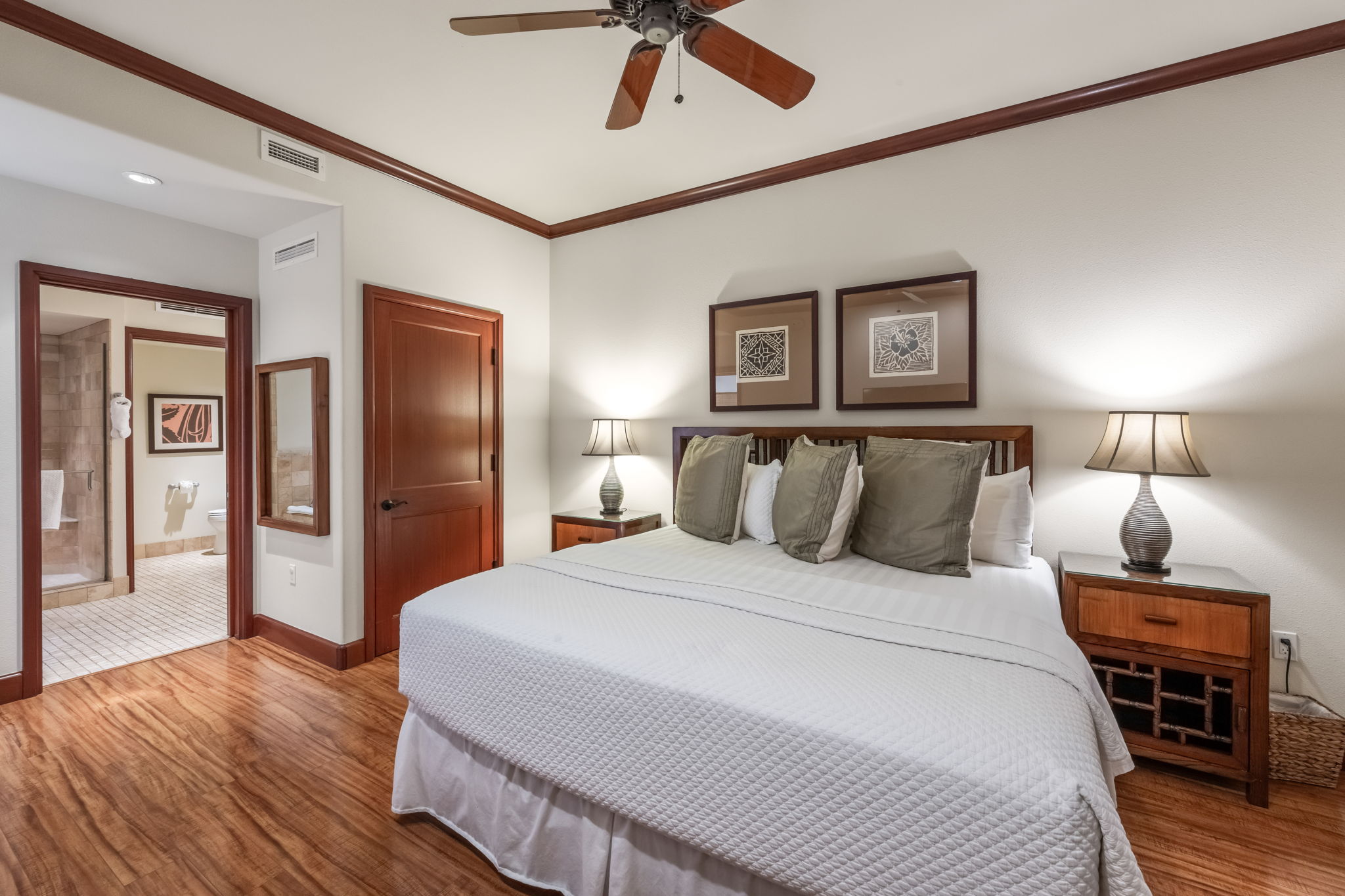 69-1000 Kolea Kai Circle, Unit 14H Waikoloa, HI 96738 - Photo 19 of 29 a bedroom with a bed and wooden floor