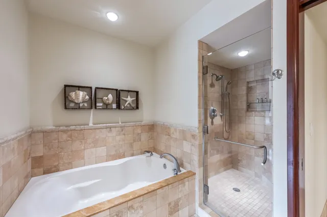 a bathroom with a bathtub and shower