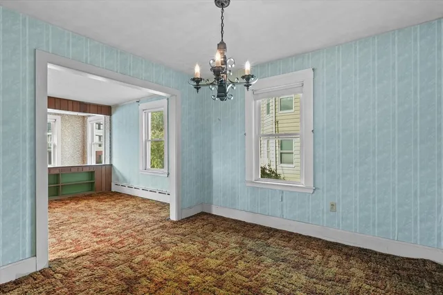 a bathroom with a tub a window and a sink
