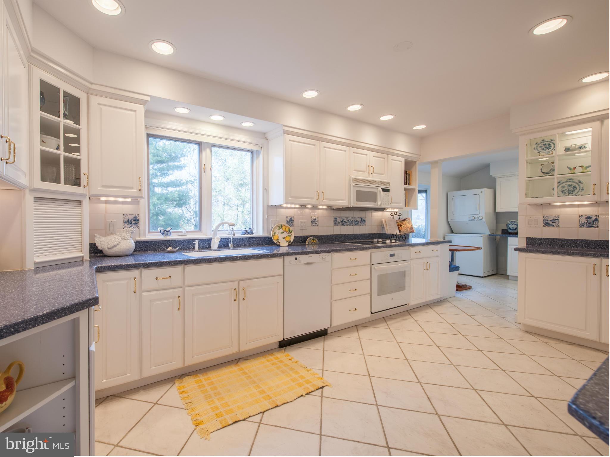 257 Providence Road Annapolis, MD 21409 - Photo 14 of 30 a large white kitchen with cabinets