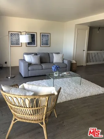 a living room with furniture and a rug